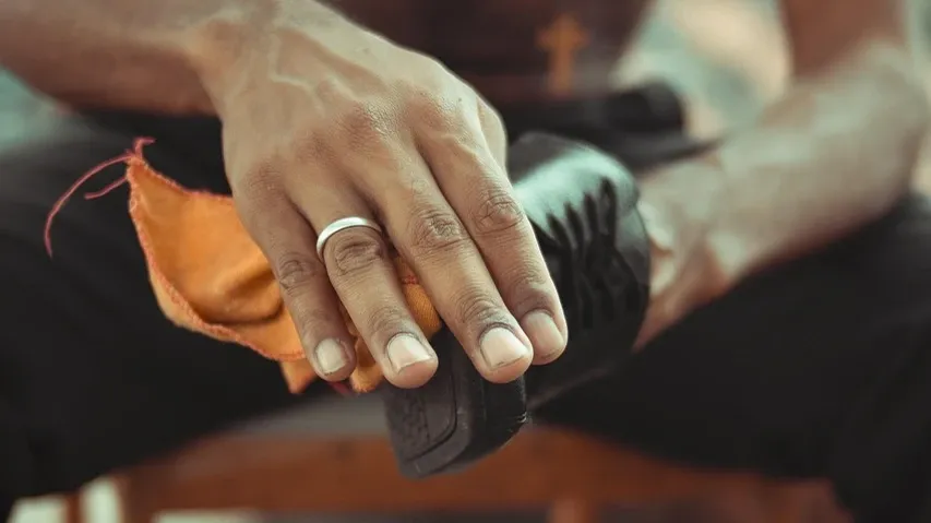 Remove dirt and dust from shoes with a stiff brush